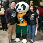 U of A mascot, Patches, posing with two of the Centennial Ambassador Street Team members.